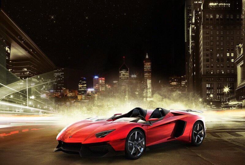 Red sports car in city at night