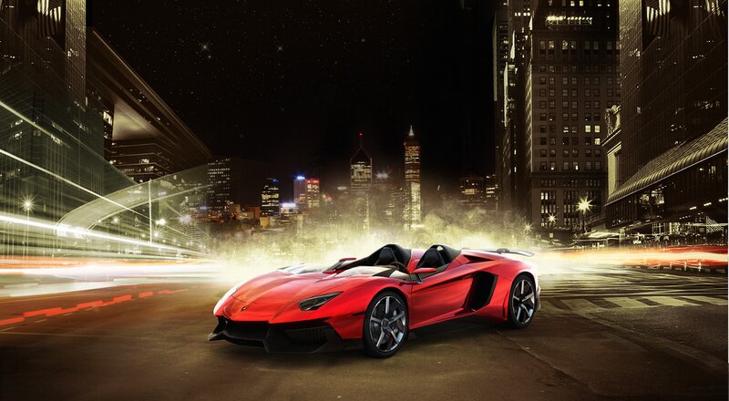Red sports car in city at night