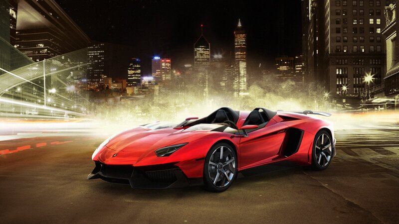 Red sports car in city at night