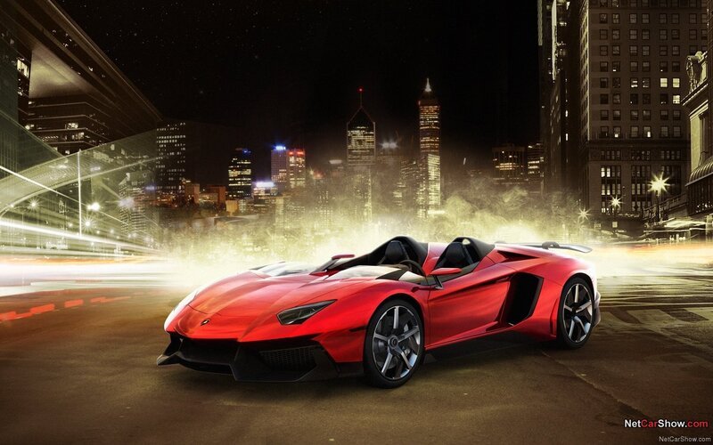 Red sports car in city at night