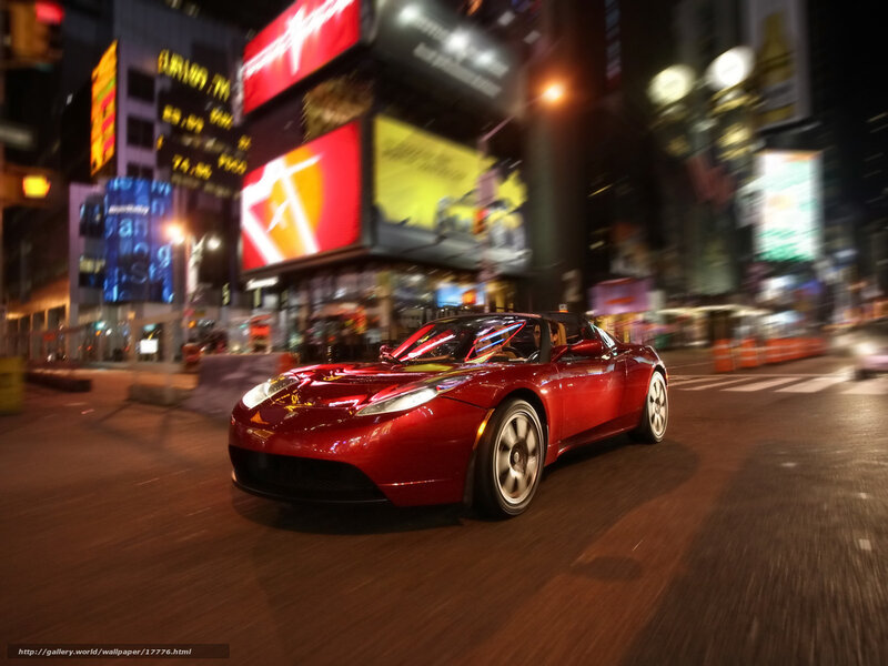 Red sports car in city at night