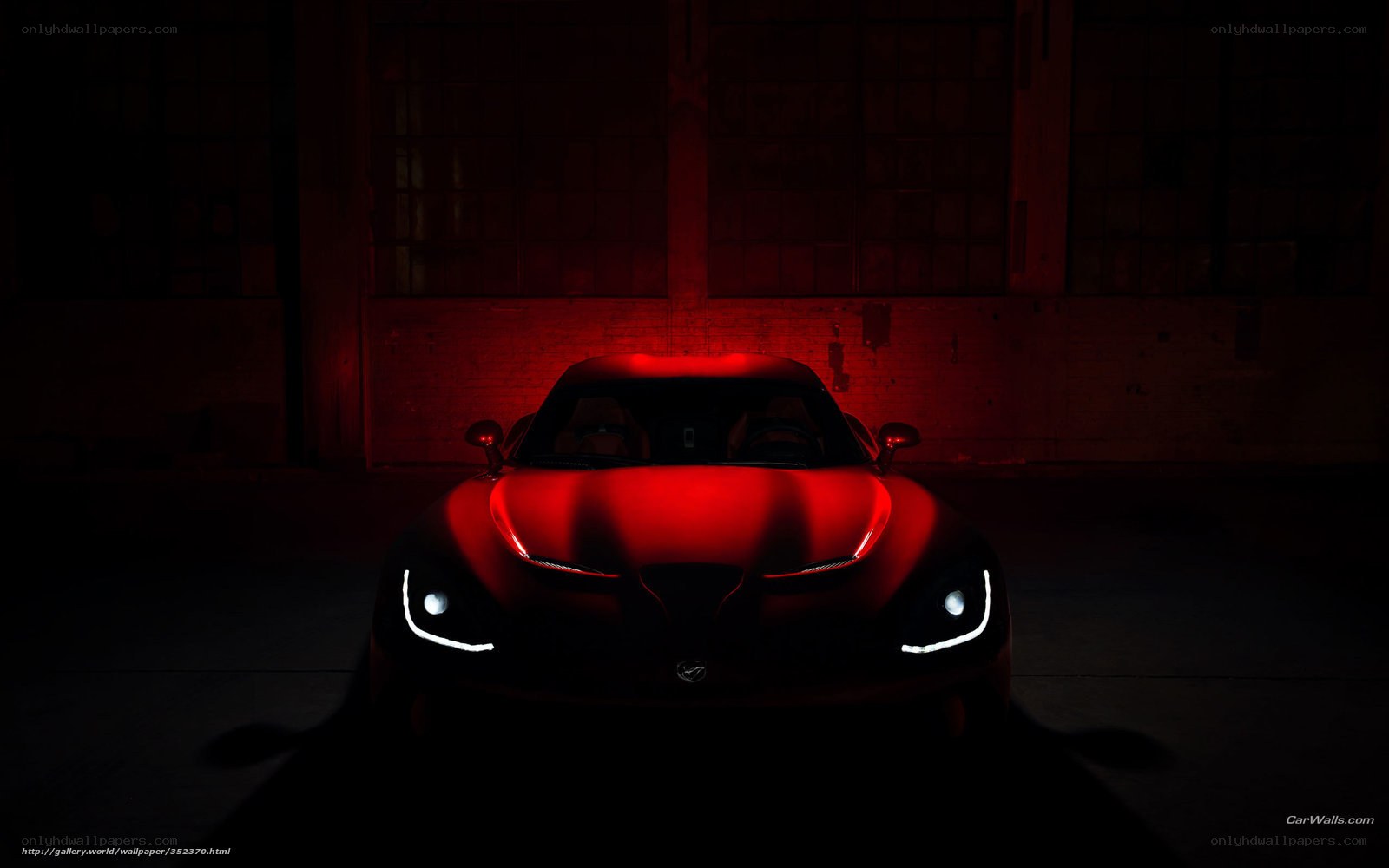Red sports car in dark garage
