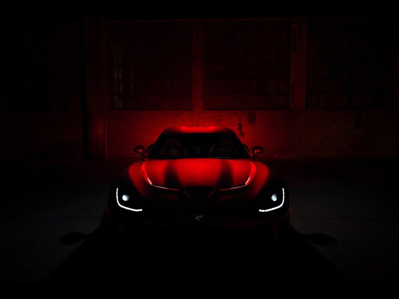 Red sports car in dark garage