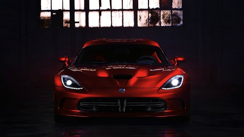 Red sports car in dark garage