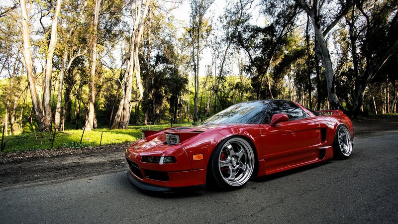 Red sports car in forest