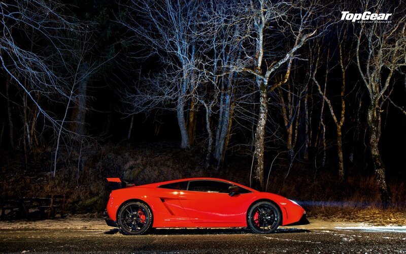 Red sports car in forest at night