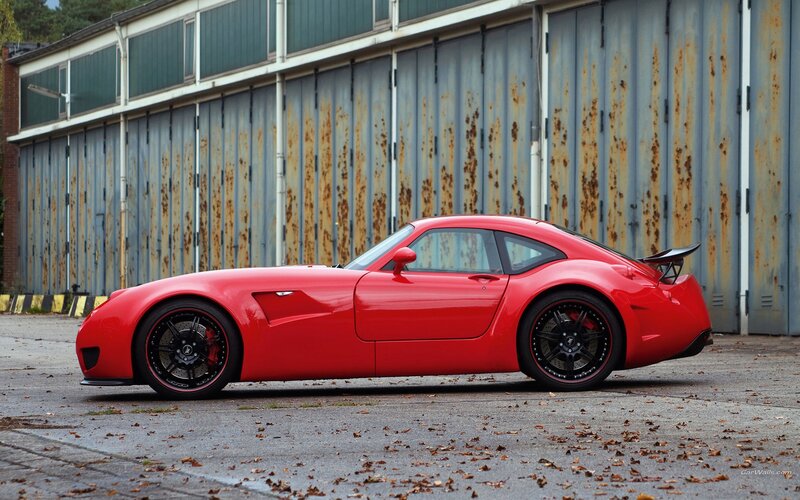 red sports car in front of garage
