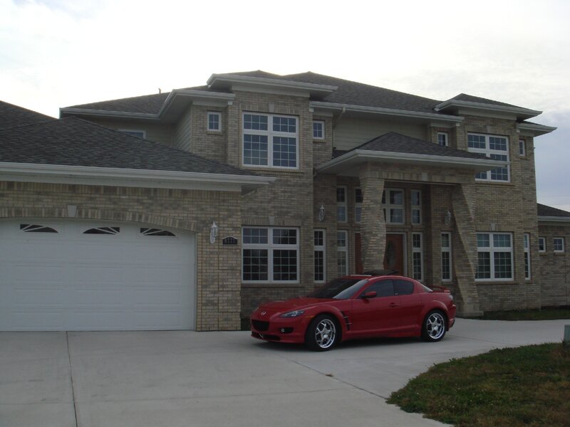 Red sports car in front of house