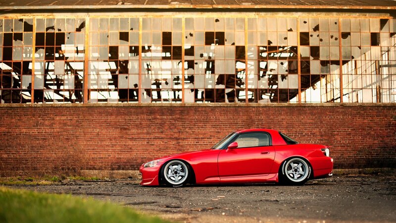 Red sports car in front of old building