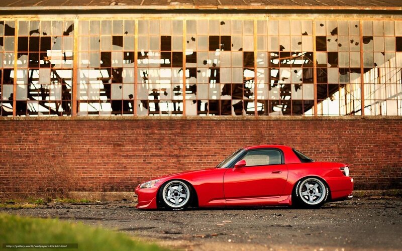Red sports car in front of old building