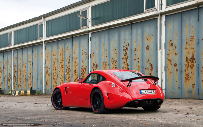 Red sports car in industrial setting
