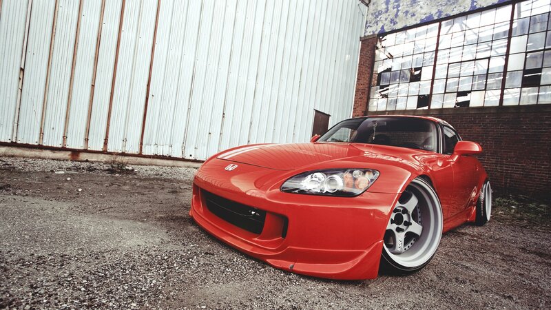 red sports car in industrial setting