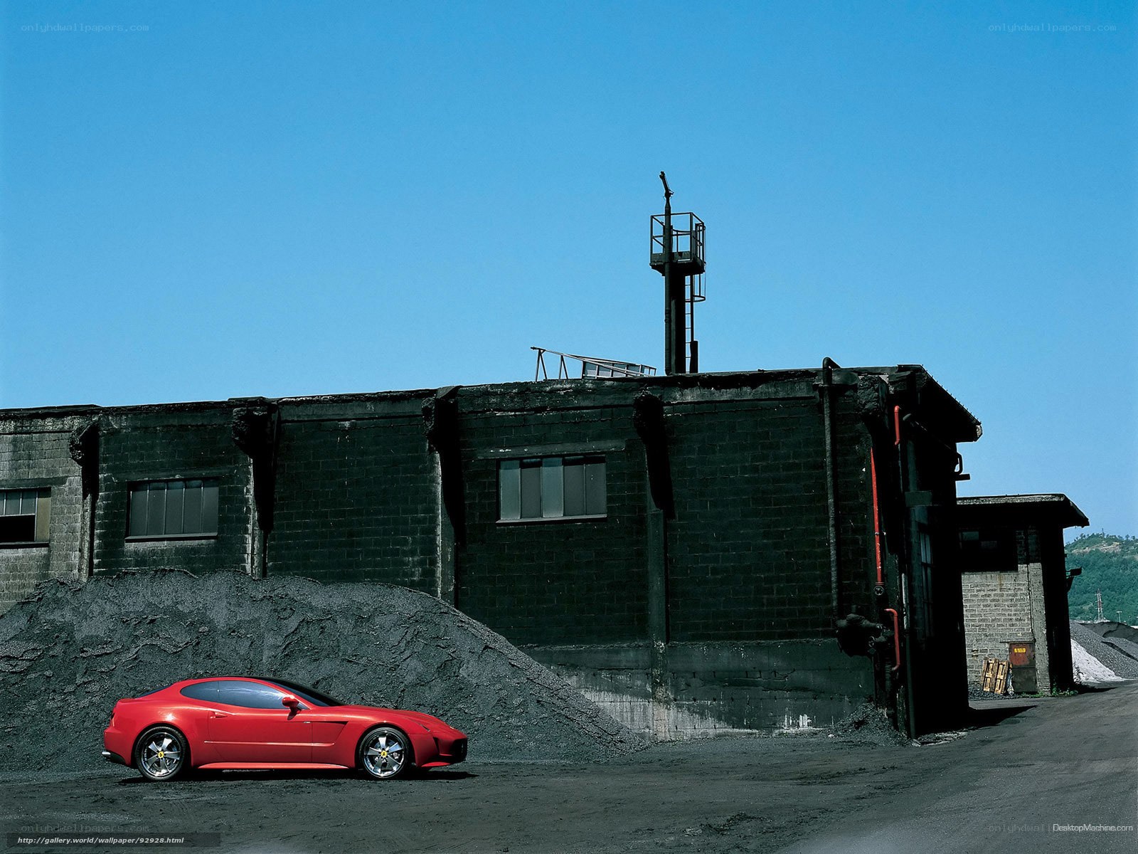 Red sports car in industrial setting