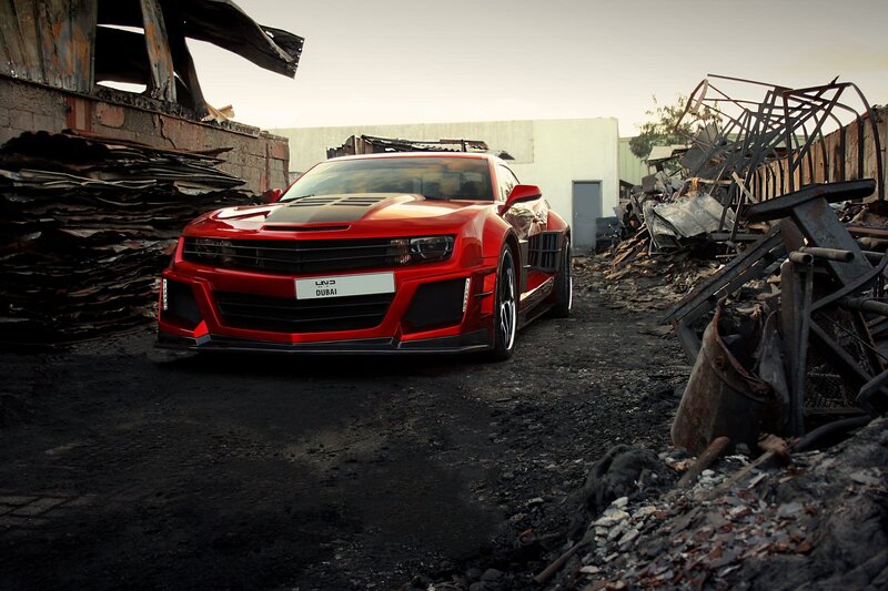 Red sports car in junkyard