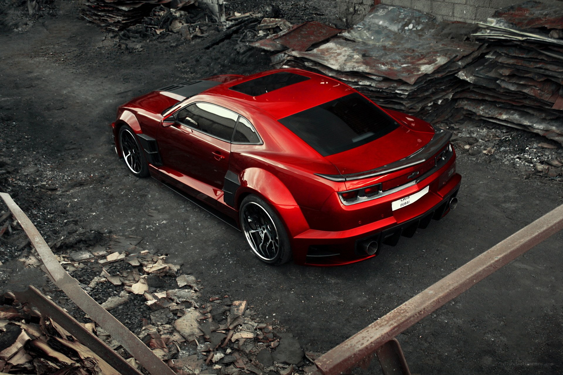 Red sports car in junkyard
