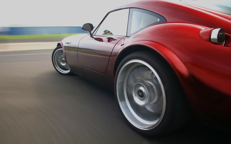 red sports car in motion