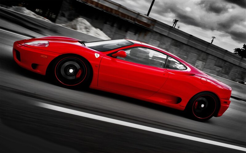 red sports car in motion