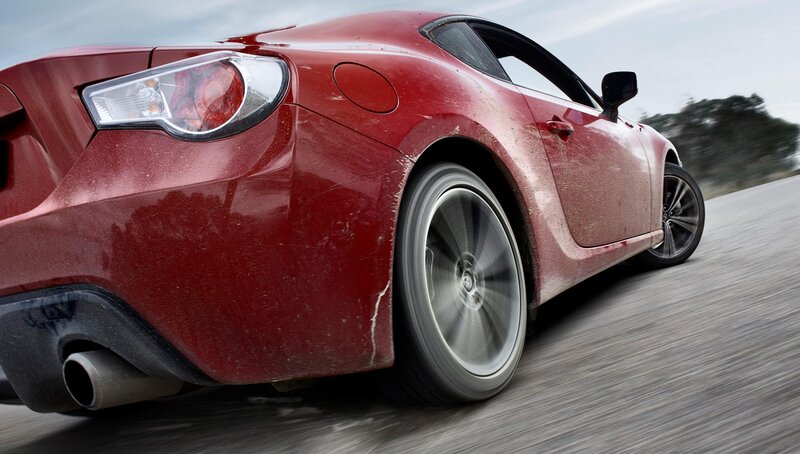 red sports car in motion