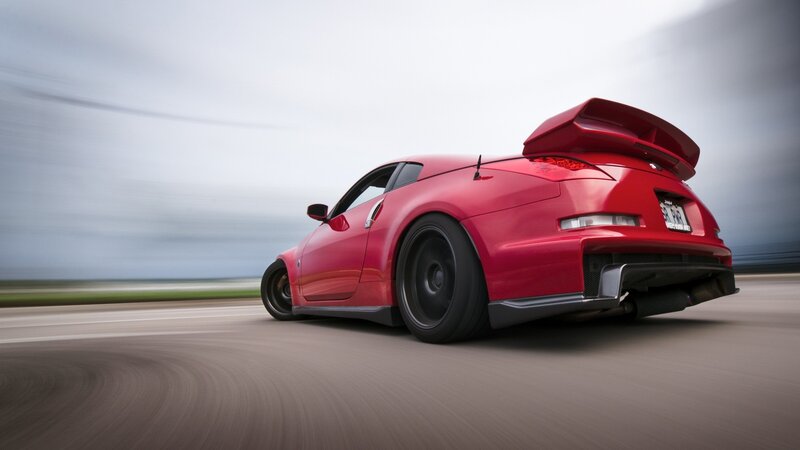red sports car in motion