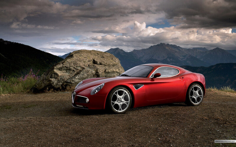 Red sports car in mountain landscape