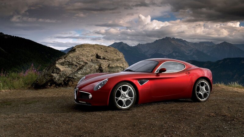 Red sports car in mountain landscape