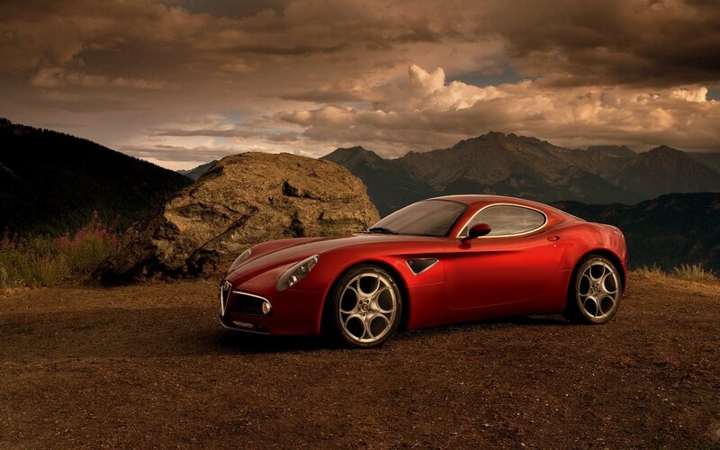 Red sports car in mountain landscape