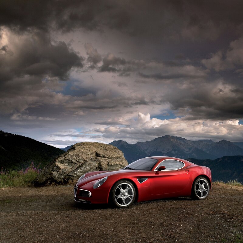 Red sports car in mountain landscape