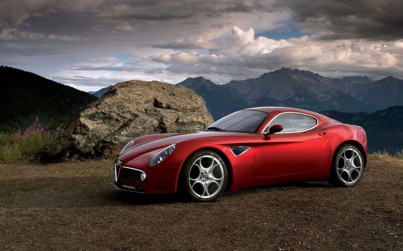 Red sports car in mountain landscape