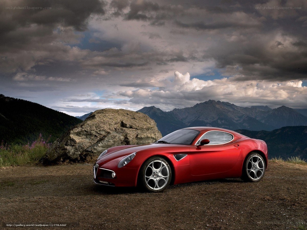 Red sports car in mountain landscape