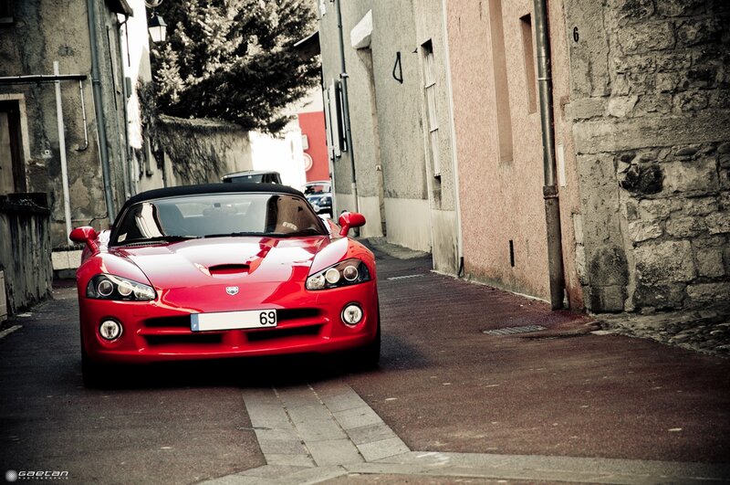 Red sports car in narrow alley