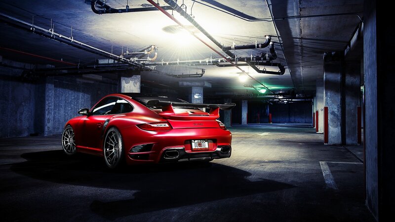 Red sports car in parking garage