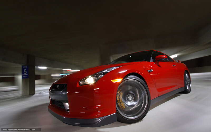 Red sports car in parking garage