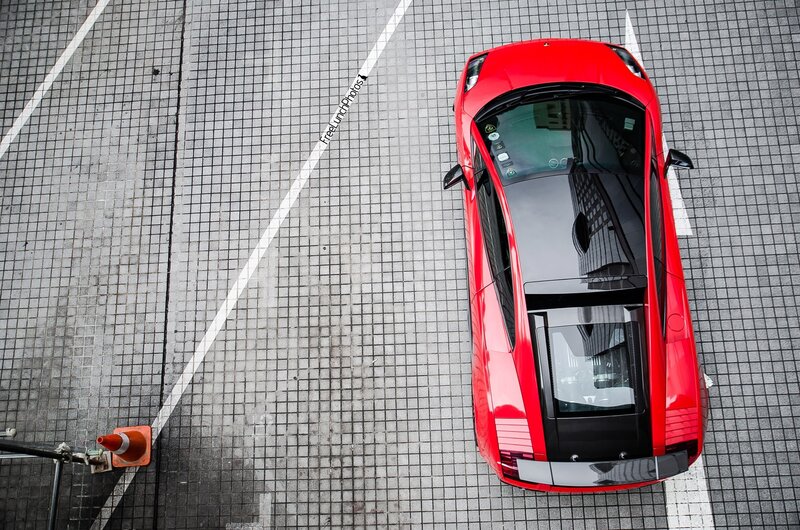 Red sports car in parking lot