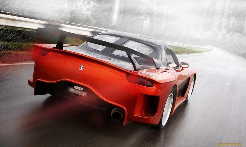 red sports car in rain