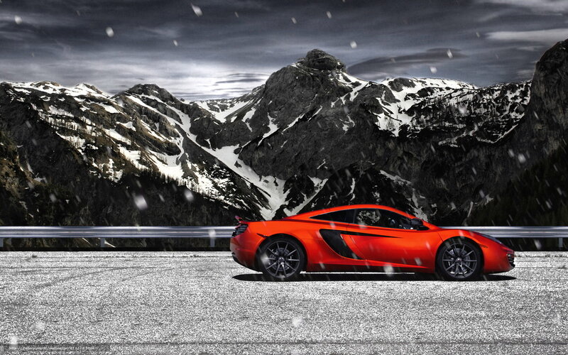 Red sports car in snowy mountains