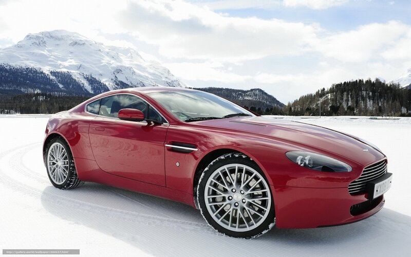 Red sports car in snowy mountains