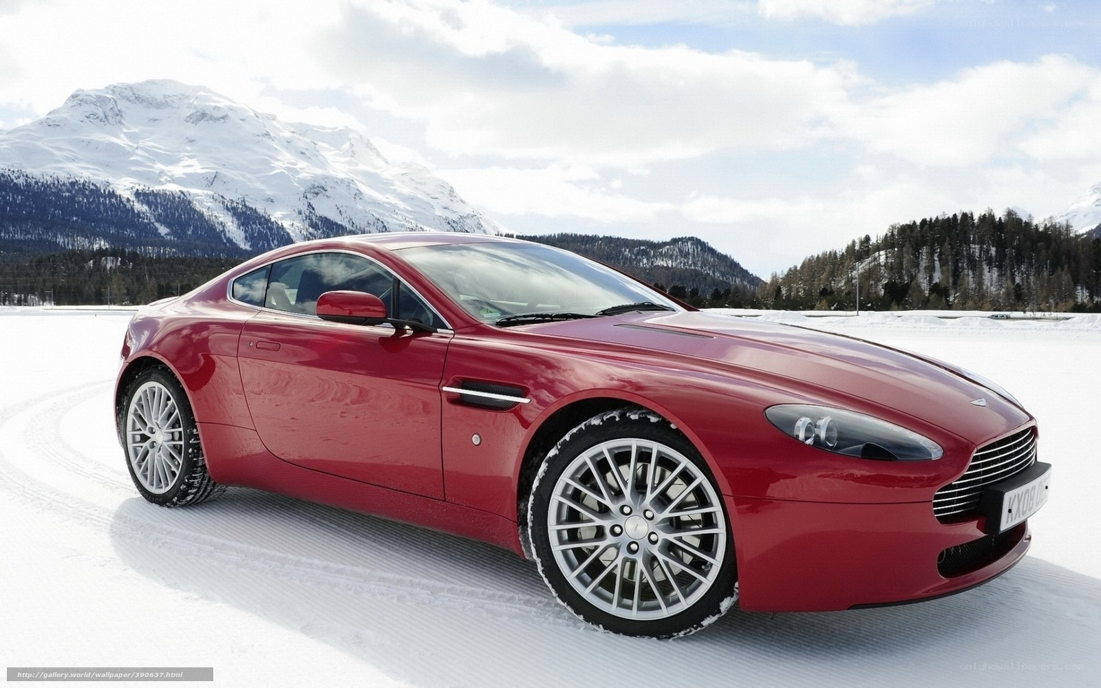 Red sports car in snowy mountains