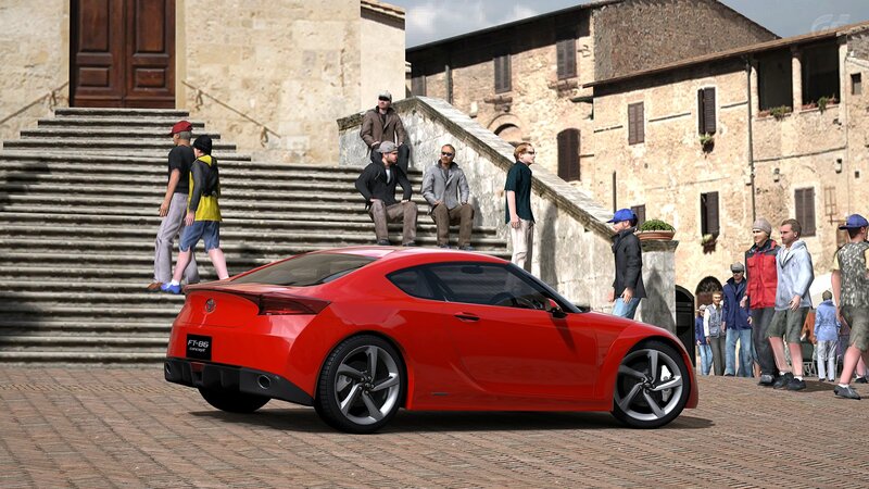 Red sports car in town square
