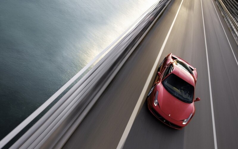 Red sports car on a bridge