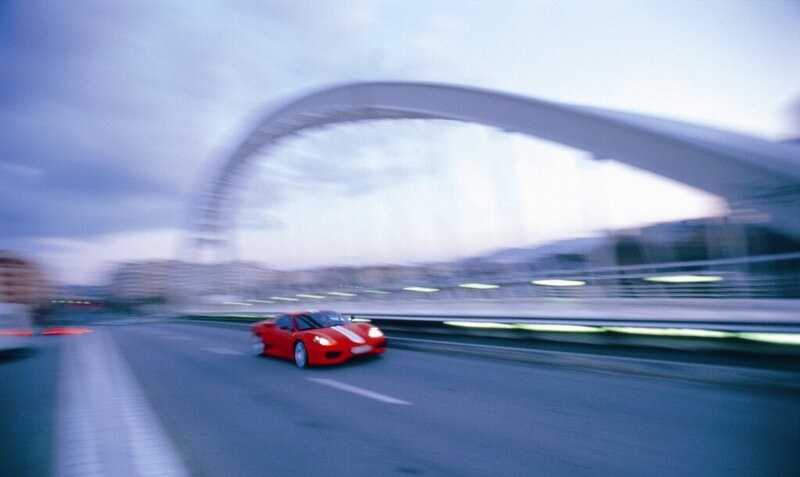 Red sports car on a bridge
