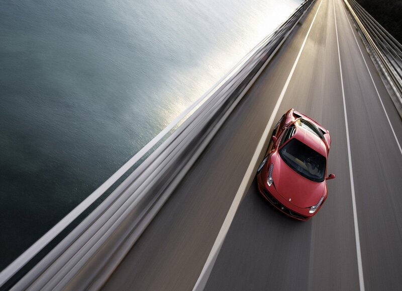 Red sports car on a bridge