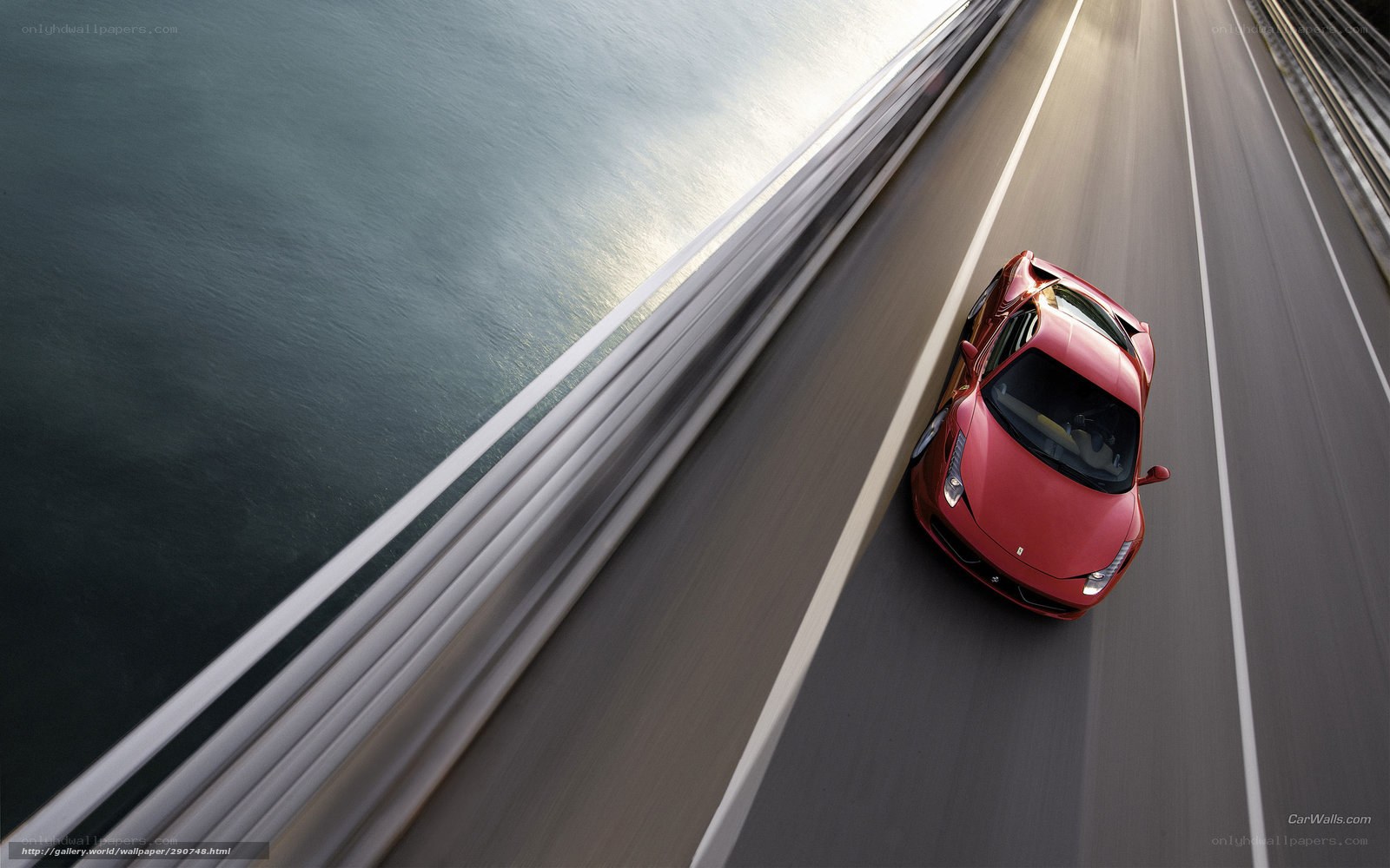 Red sports car on a bridge