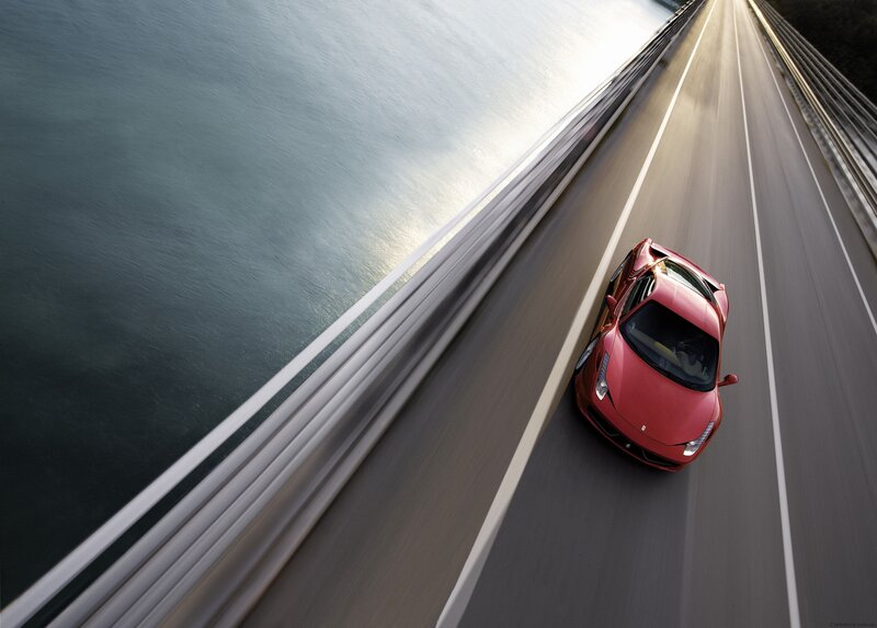 Red sports car on a bridge