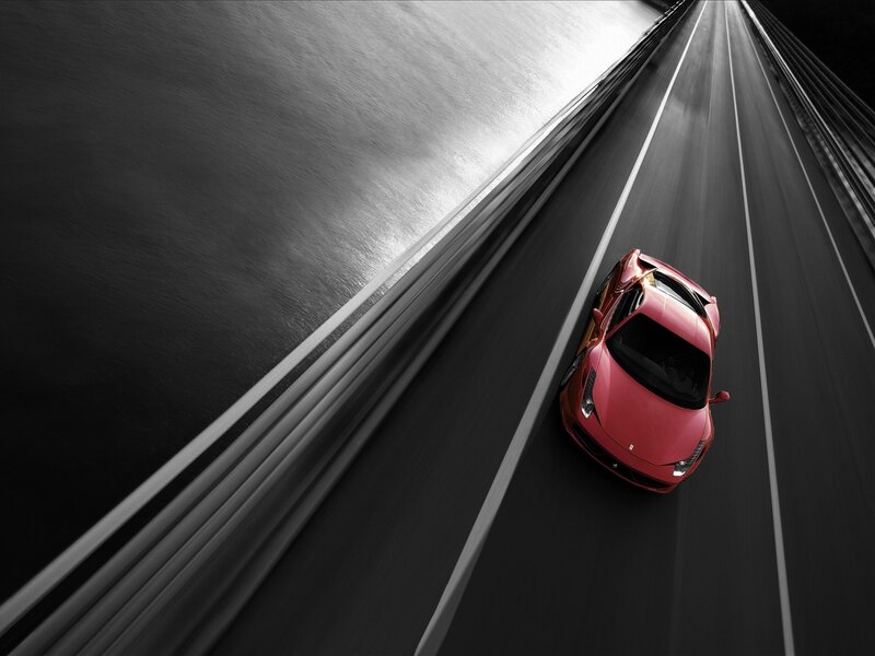 Red sports car on a bridge
