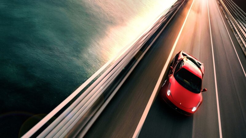 Red sports car on a bridge