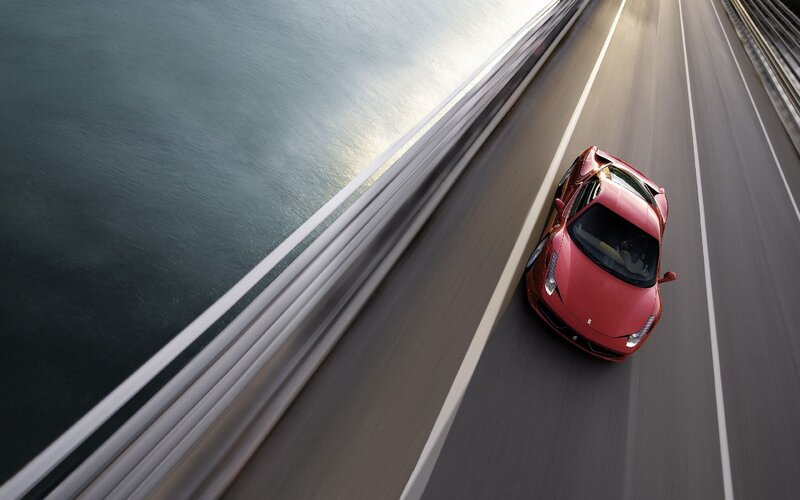 Red sports car on a bridge