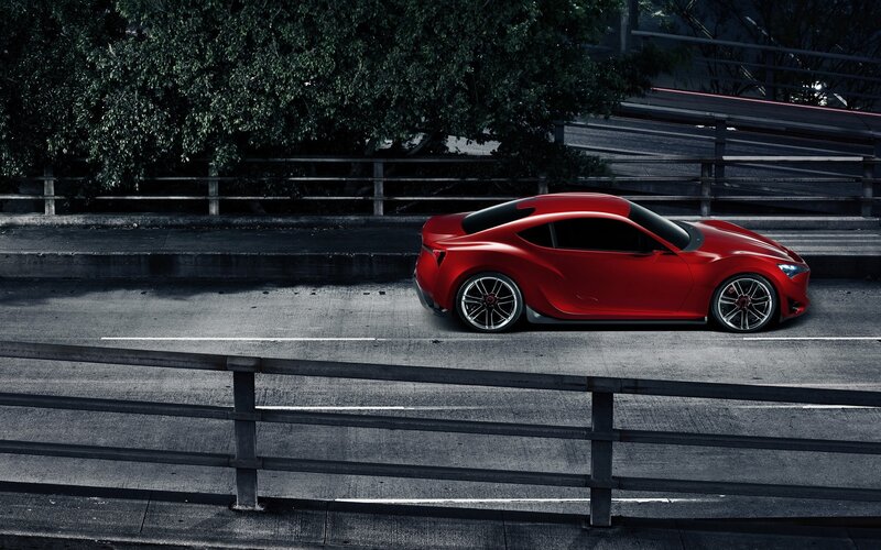 Red sports car on a bridge