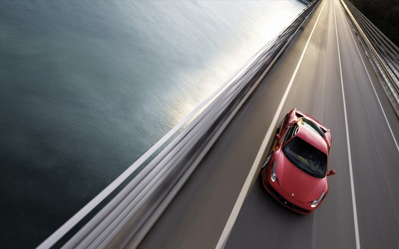 Red sports car on a bridge
