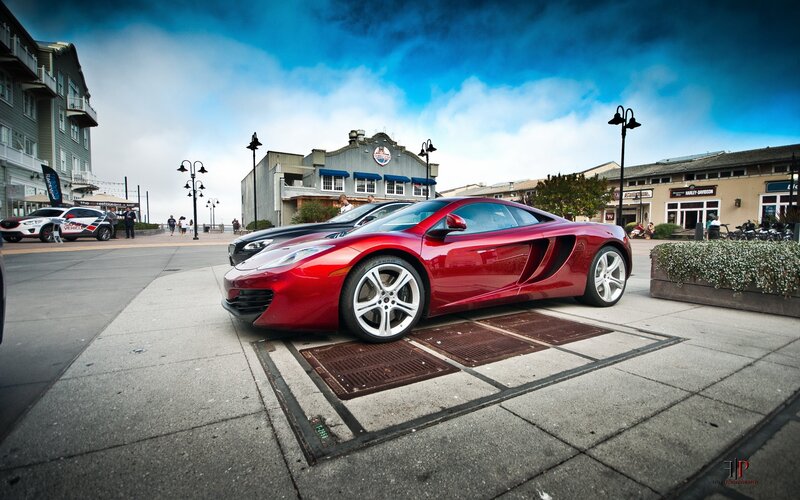 Red sports car on a city street