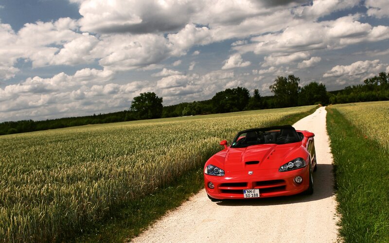 Red sports car on a country road
